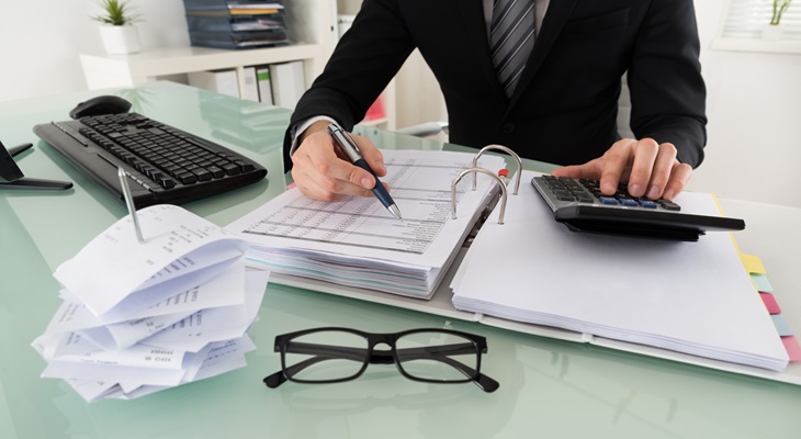 Primo piano uomo che calcola imposte In ufficio